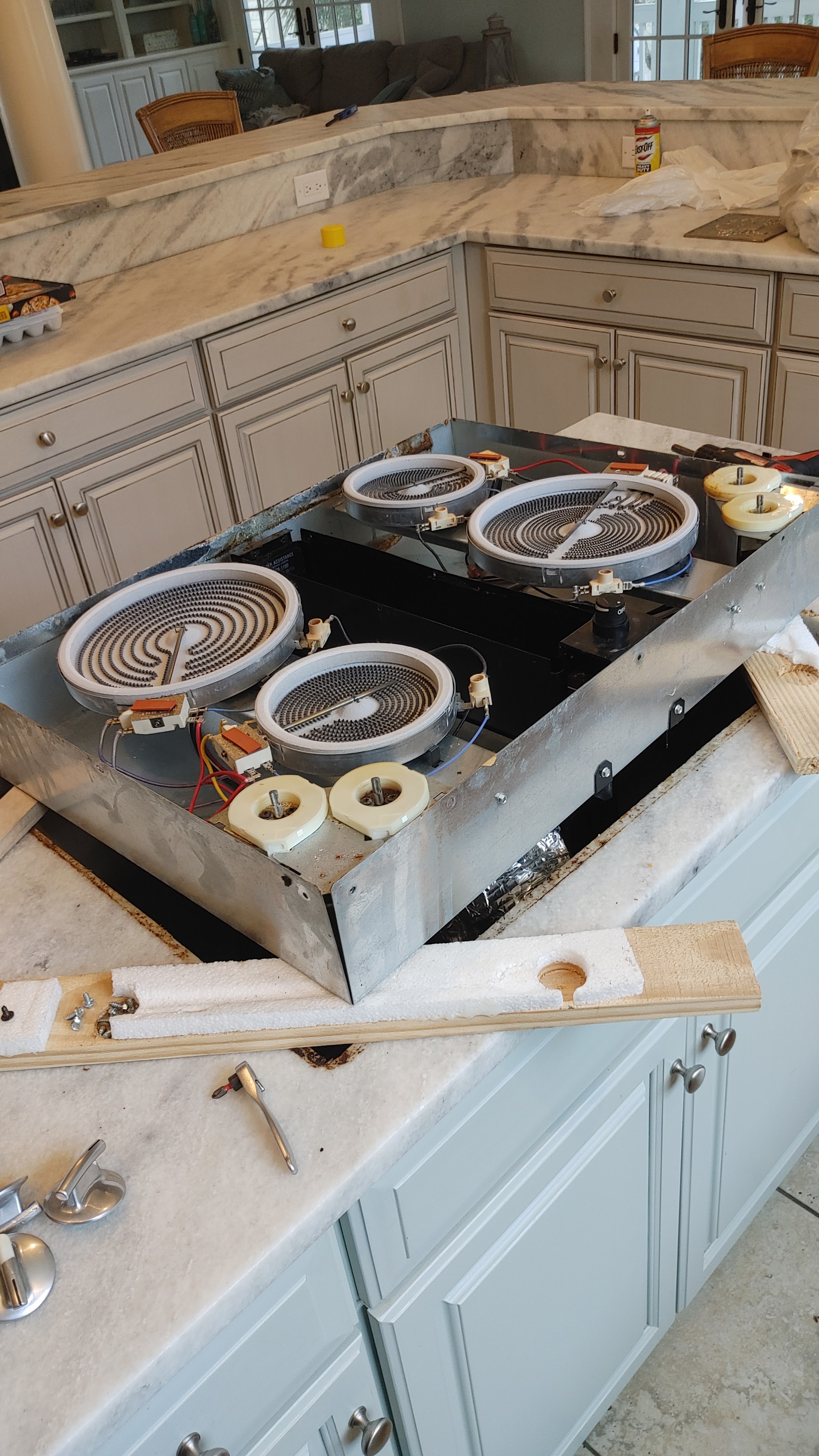 Cooktop elements exposed during a repair