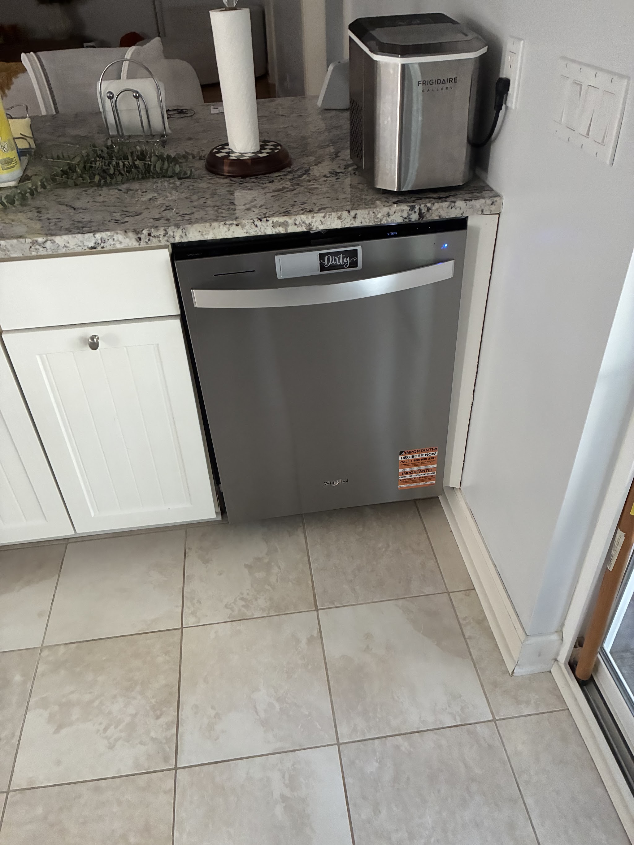 Stainless dishwasher installed under a counter